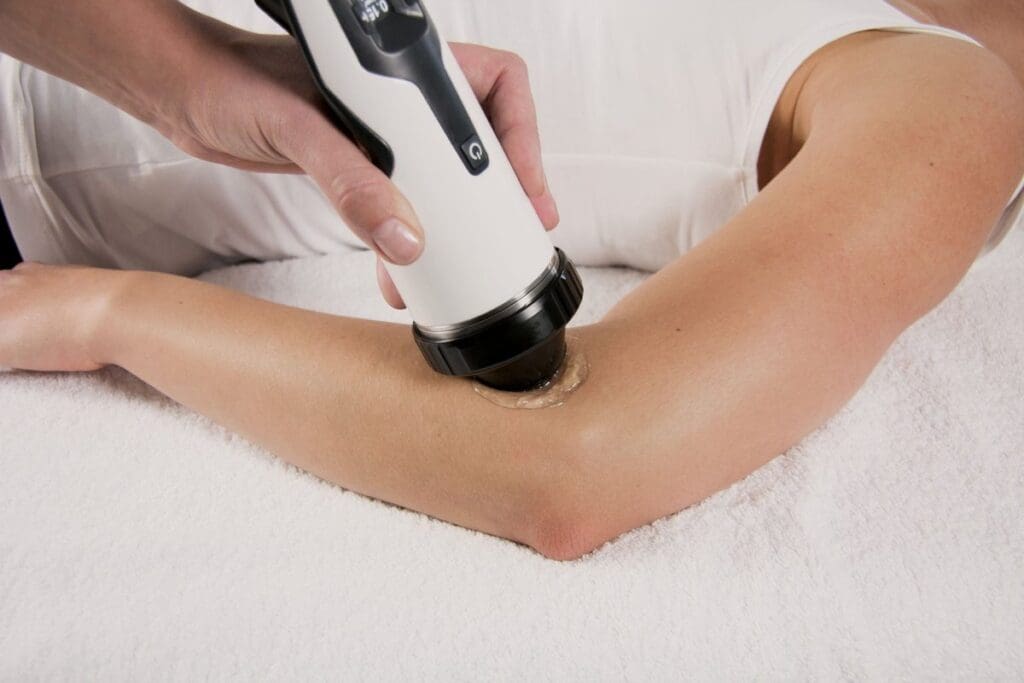 shockwave therapy being applied to a patient's elbow for pain relief